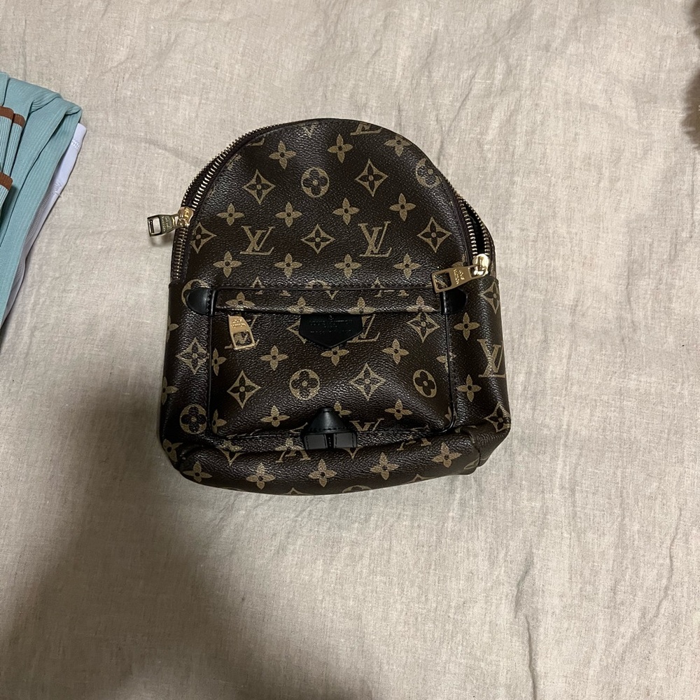 Brown and gold leather backpack